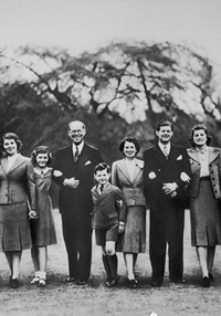 Joseph Kennedy Sr. (fifth from left) and his wife Rose (fifth from right) pose for a family portrait on the grounds of the U.S. embassy in London, where Joe was serving as U.S. ambassador to the U.K.